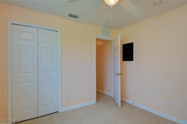 304 NW 22nd Ave, Cape Coral, FL 33993 - unfurnished bedroom with light tile patterned floors, ceiling fan, and a closet