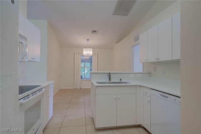 304 NW 22nd Ave, Cape Coral, FL 33993 - kitchen with white appliances, a peninsula, vaulted ceiling, white cabinets, and light countertops