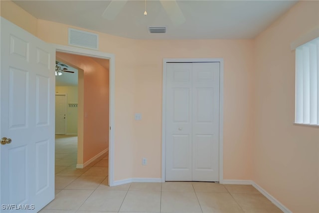 304 NW 22nd Ave, Cape Coral, FL 33993 - unfurnished bedroom featuring light tile patterned flooring, a closet, and a ceiling fan