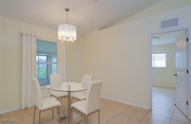 304 NW 22nd Ave, Cape Coral, FL 33993 - dining room featuring a chandelier, light tile patterned floors, and vaulted ceiling