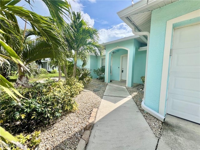304 NW 22nd Ave, Cape Coral, FL 33993 - view of exterior entry with stucco siding