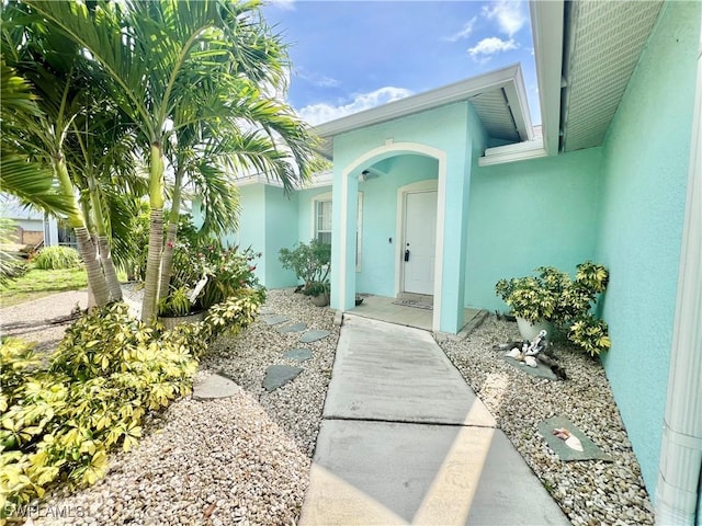 304 NW 22nd Ave, Cape Coral, FL 33993 - doorway to property featuring stucco siding