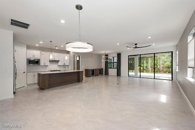 16569 Windsor Way, Alva, FL 33920 - kitchen with open floor plan, stainless steel appliances, recessed lighting, under cabinet range hood, and light countertops