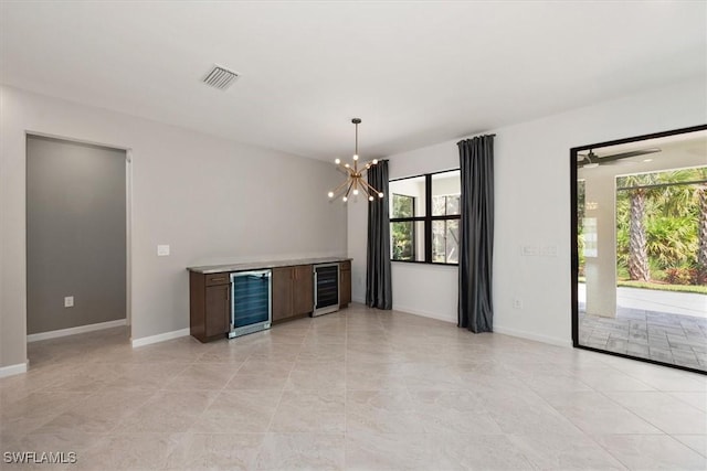 16569 Windsor Way, Alva, FL 33920 - unfurnished room featuring beverage cooler, a chandelier, and a bar