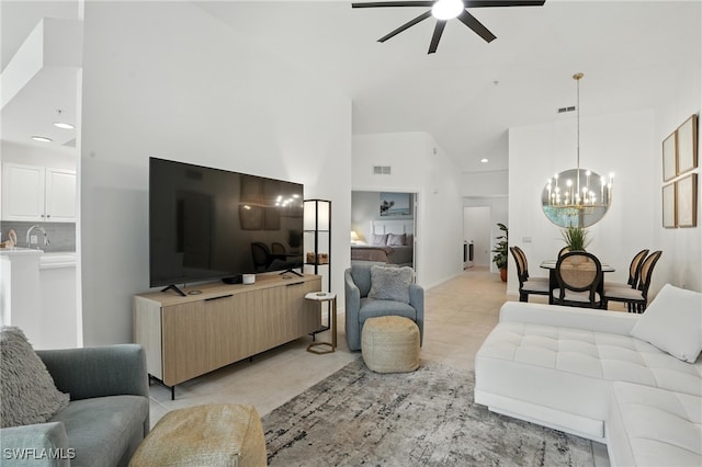 3425 Laurel Greens Ln S Unit 203, Naples, FL 34119 - living area featuring a ceiling fan, a chandelier, high vaulted ceiling, light tile patterned floors, and recessed lighting