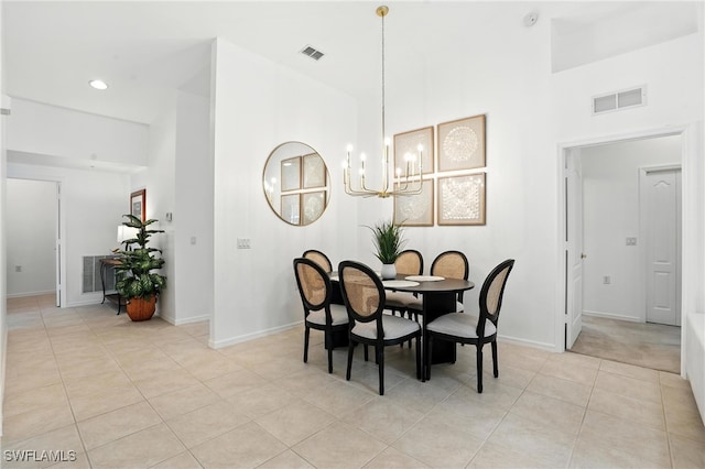 3425 Laurel Greens Ln S Unit 203, Naples, FL 34119 - dining room featuring light tile patterned floors, a chandelier, a high ceiling, and recessed lighting