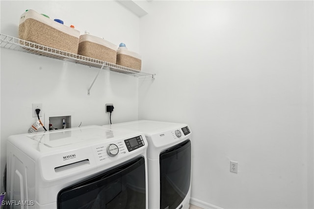 3425 Laurel Greens Ln S Unit 203, Naples, FL 34119 - laundry area with washing machine and clothes dryer and baseboards