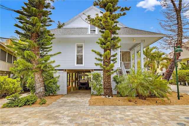 33 Urchin Ct, Captiva, FL 33924 - coastal inspired home with a carport and roof with shingles