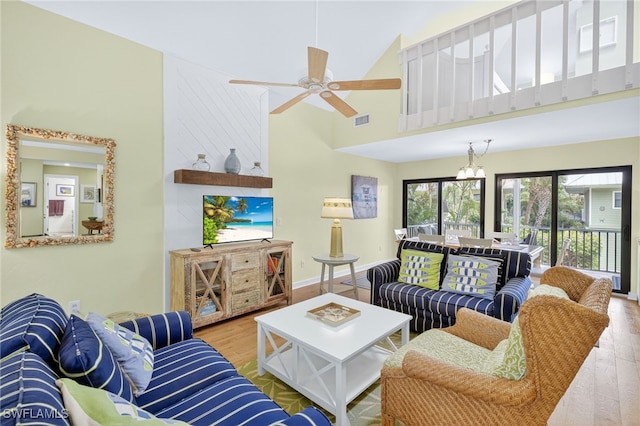 33 Urchin Ct, Captiva, FL 33924 - living room featuring wood finished floors, ceiling fan, and a high ceiling