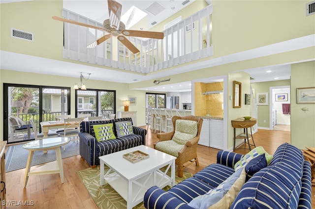 33 Urchin Ct, Captiva, FL 33924 - living room featuring plenty of natural light, a high ceiling, wood finished floors, a ceiling fan, and recessed lighting