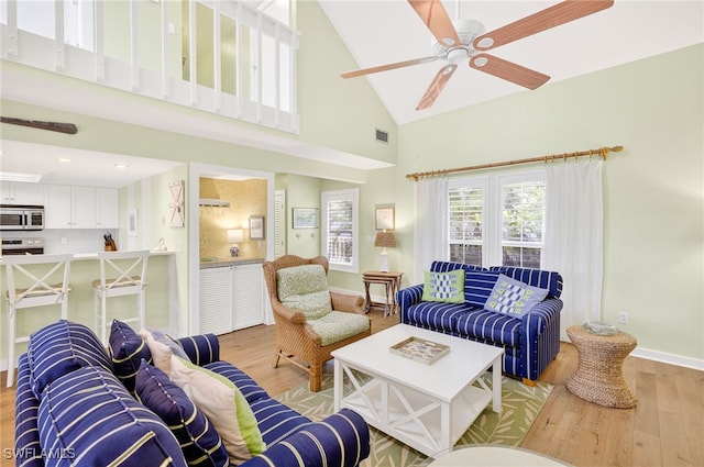 33 Urchin Ct, Captiva, FL 33924 - living room with light wood-style flooring, high vaulted ceiling, and a ceiling fan