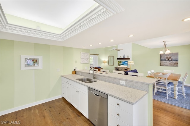 33 Urchin Ct, Captiva, FL 33924 - kitchen with dishwasher, a peninsula, dark wood-style flooring, white cabinetry, and recessed lighting