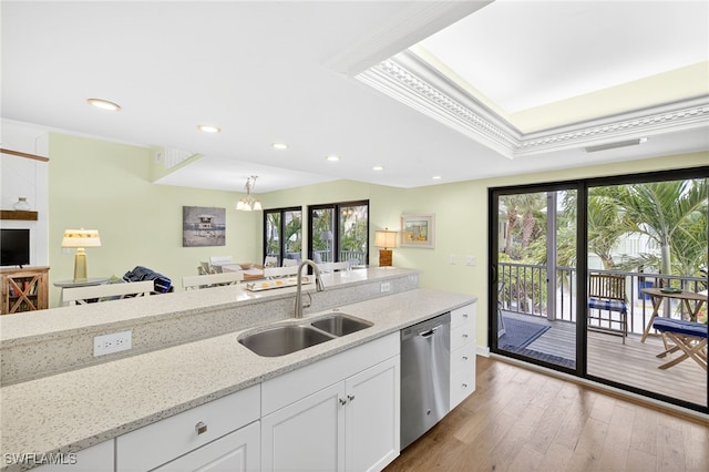 33 Urchin Ct, Captiva, FL 33924 - kitchen featuring dishwasher, white cabinetry, plenty of natural light, wood finished floors, and crown molding
