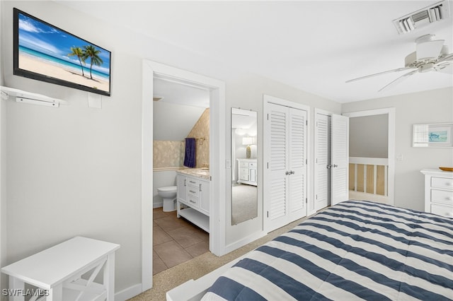 33 Urchin Ct, Captiva, FL 33924 - bedroom with light tile patterned floors, a ceiling fan, connected bathroom, and a closet