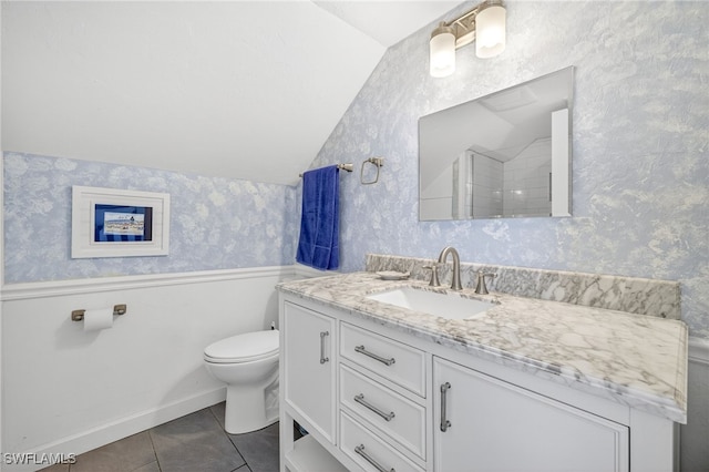 33 Urchin Ct, Captiva, FL 33924 - full bath featuring vaulted ceiling, vanity, wallpapered walls, tile patterned floors, and a shower