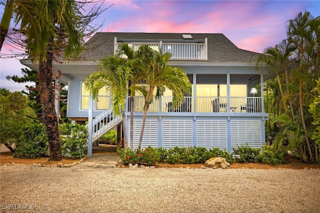 33 Urchin Ct, Captiva, FL 33924 - raised beach house with stairway and a shingled roof