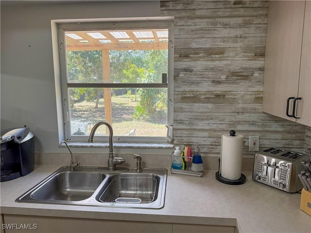 5870 Star Grass Ln, Naples, FL 34116 - kitchen with light countertops, healthy amount of natural light, and wooden walls