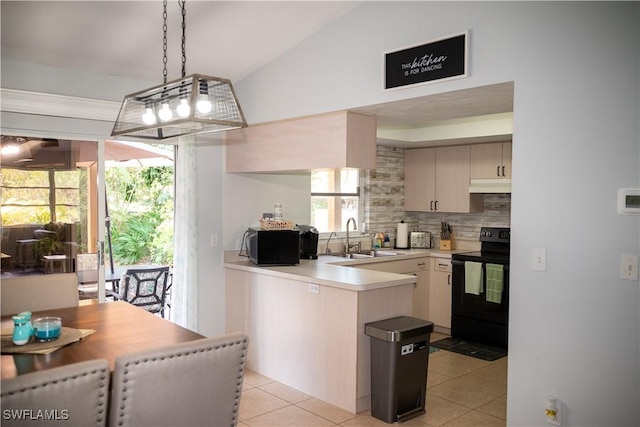 5870 Star Grass Ln, Naples, FL 34116 - kitchen featuring black appliances, backsplash, a peninsula, under cabinet range hood, and light tile patterned floors