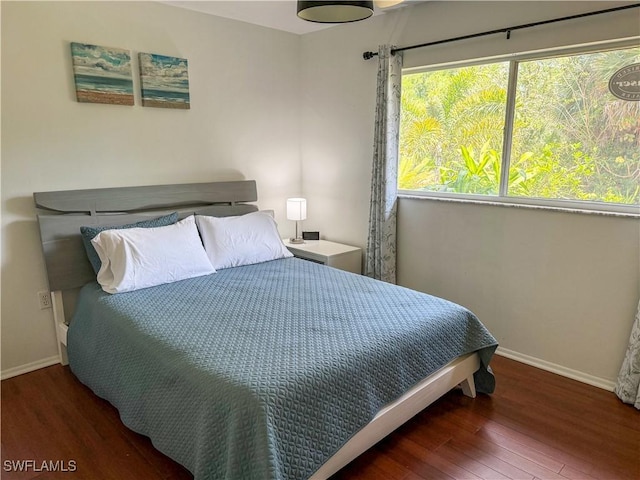 5870 Star Grass Ln, Naples, FL 34116 - bedroom with baseboards and wood finished floors