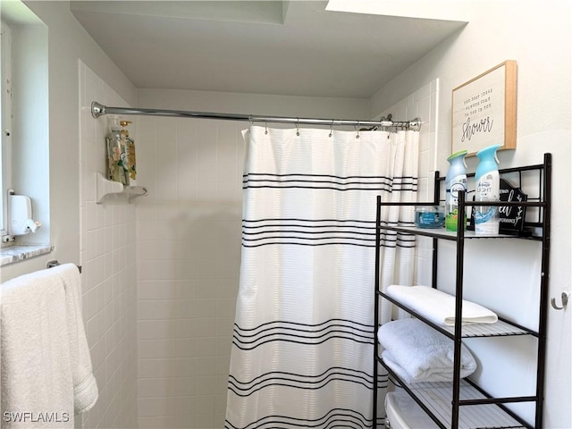 5870 Star Grass Ln, Naples, FL 34116 - bathroom featuring a shower with shower curtain and toilet