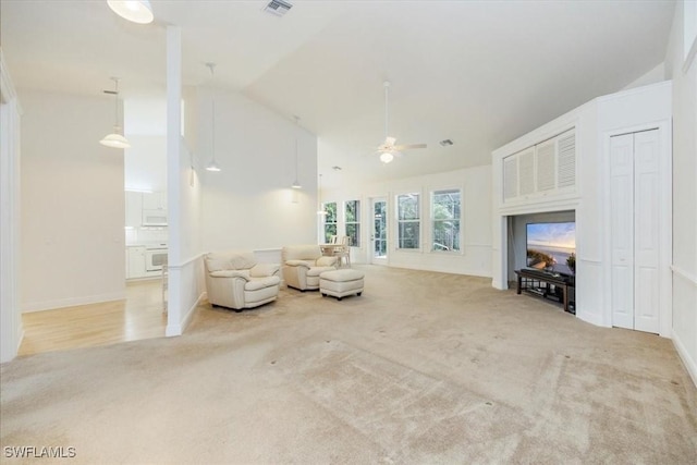 2457 Dorset Ct, Naples, FL 34112 - carpeted living room featuring a ceiling fan and high vaulted ceiling