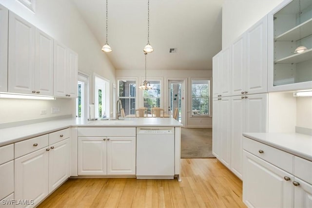 2457 Dorset Ct, Naples, FL 34112 - kitchen featuring dishwasher, a peninsula, light wood finished floors, light countertops, and lofted ceiling