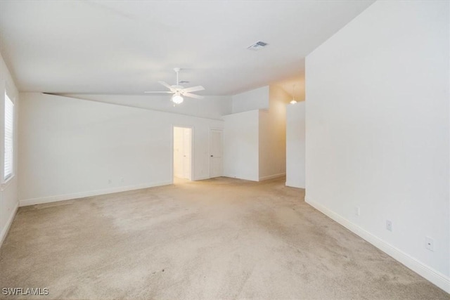 2457 Dorset Ct, Naples, FL 34112 - empty room featuring ceiling fan, light colored carpet, and vaulted ceiling