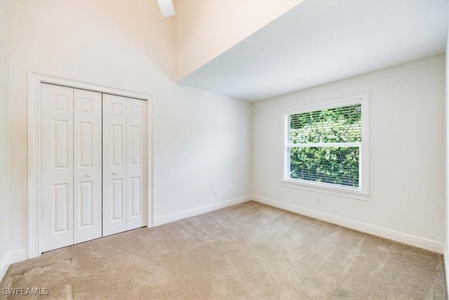2457 Dorset Ct, Naples, FL 34112 - unfurnished bedroom with carpet floors, a closet, and a ceiling fan
