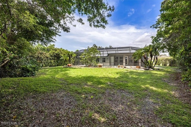 2457 Dorset Ct, Naples, FL 34112 - view of green lawn with glass enclosure