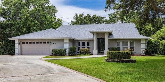 2457 Dorset Ct, Naples, FL 34112 - view of front of house featuring stucco siding, an attached garage, concrete driveway, and a front lawn