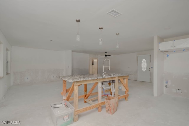 330 Shore Dr, Fort Myers, FL 33905 - kitchen with white cabinets, decorative light fixtures, open floor plan, ceiling fan, and concrete flooring