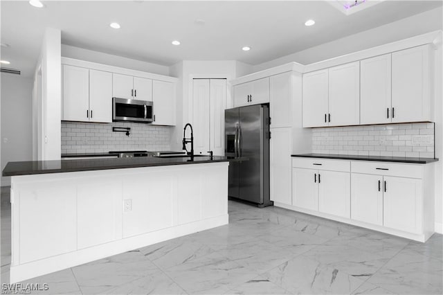 5300 3rd St W, Lehigh Acres, FL 33971 - kitchen featuring dark countertops, appliances with stainless steel finishes, decorative backsplash, and recessed lighting