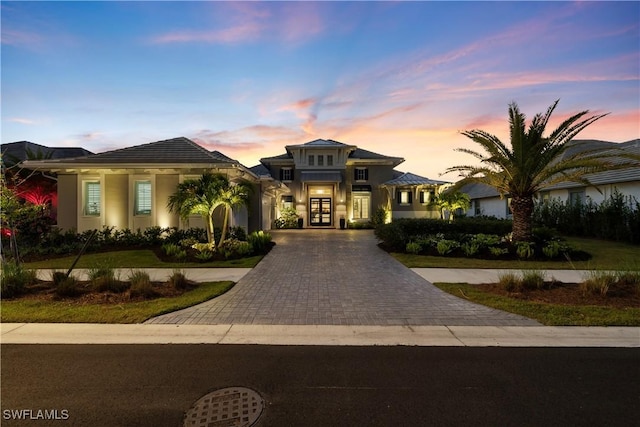 8923 Nevis Way, Naples, FL 34112 - view of front of home featuring french doors, decorative driveway, and stucco siding