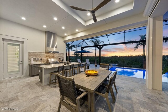 8923 Nevis Way, Naples, FL 34112 - dining area featuring stone tile floors, a ceiling fan, healthy amount of natural light, recessed lighting, and a sunroom