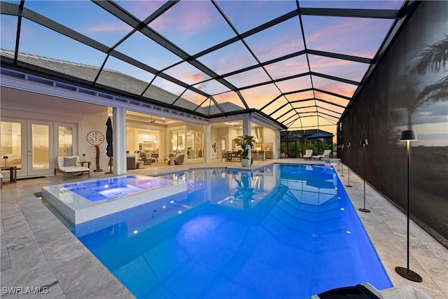 8923 Nevis Way, Naples, FL 34112 - pool at dusk featuring a ceiling fan, a patio area, an outdoor hangout area, french doors, and glass enclosure