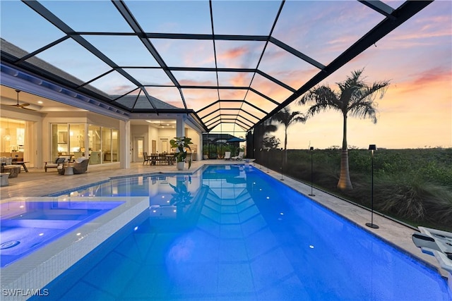 8923 Nevis Way, Naples, FL 34112 - view of swimming pool with an outdoor living space, a patio area, glass enclosure, and a pool with connected hot tub