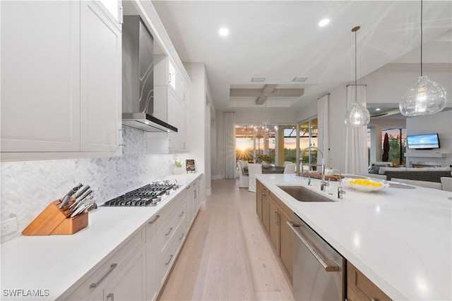 8923 Nevis Way, Naples, FL 34112 - kitchen featuring appliances with stainless steel finishes, wall chimney range hood, open floor plan, light wood-type flooring, and recessed lighting