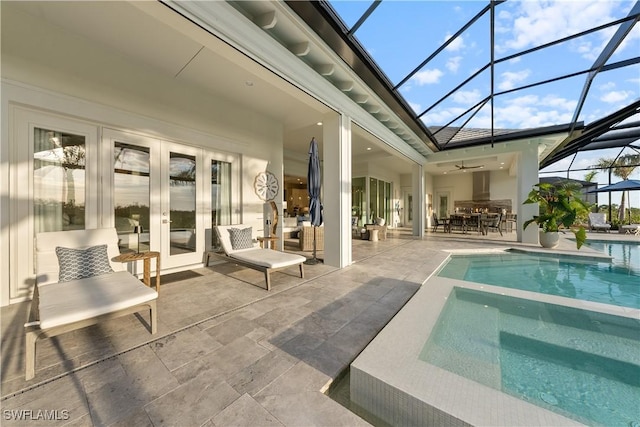 8923 Nevis Way, Naples, FL 34112 - view of pool featuring french doors, a patio area, a pool with connected hot tub, glass enclosure, and ceiling fan