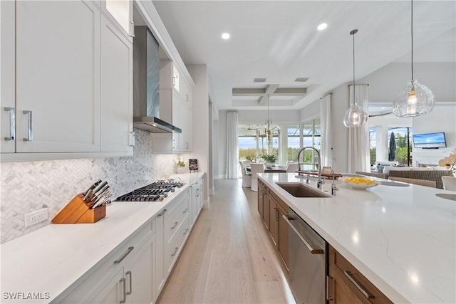 8923 Nevis Way, Naples, FL 34112 - kitchen with stainless steel appliances, wall chimney range hood, light wood-style floors, recessed lighting, and white cabinets