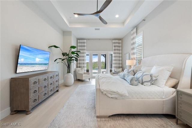 8923 Nevis Way, Naples, FL 34112 - bedroom with a tray ceiling, access to exterior, french doors, light wood finished floors, and ceiling fan