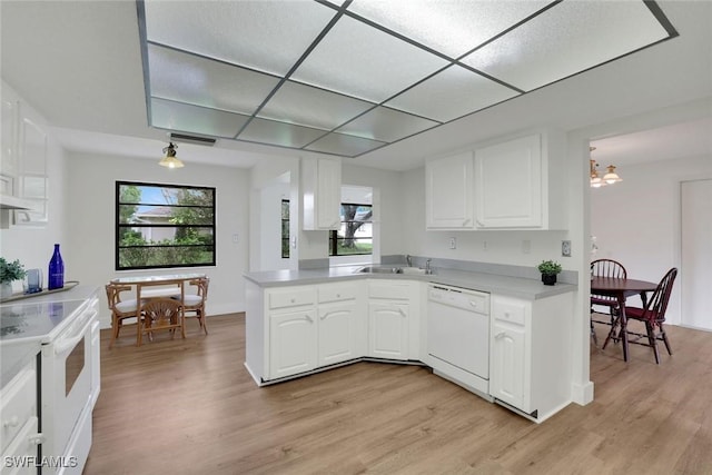 4925 Molokai Dr Unit 16, Naples, FL 34112 - kitchen with white appliances, light wood finished floors, and a peninsula