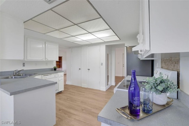 4925 Molokai Dr Unit 16, Naples, FL 34112 - kitchen featuring white dishwasher, stove, white cabinets, light wood-style floors, and a peninsula
