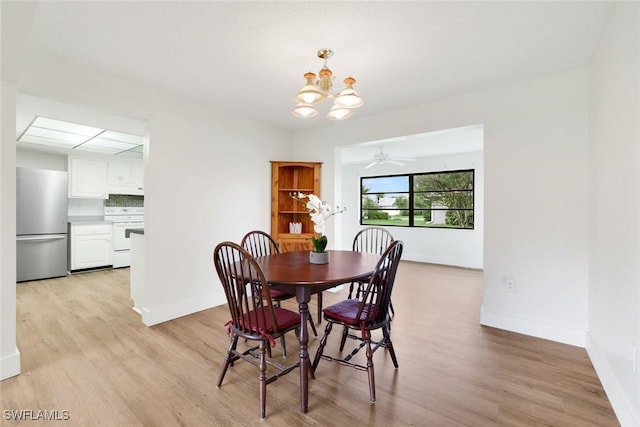 4925 Molokai Dr Unit 16, Naples, FL 34112 - dining room featuring a chandelier and light wood-style flooring