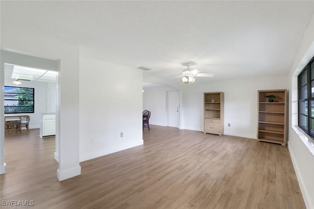 4925 Molokai Dr Unit 16, Naples, FL 34112 - unfurnished living room with light wood-type flooring, arched walkways, and a ceiling fan