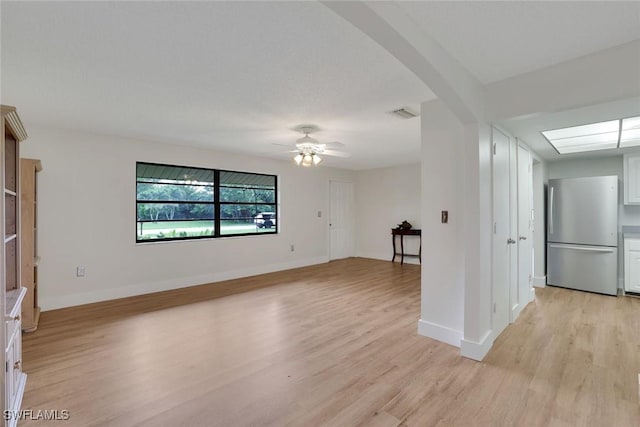 4925 Molokai Dr Unit 16, Naples, FL 34112 - empty room with light wood finished floors, a ceiling fan, and arched walkways