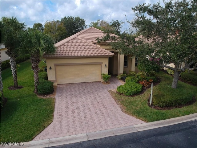 11970 Bramble Cove Dr, Fort Myers, FL 33905 - mediterranean / spanish house with an attached garage, stucco siding, a front lawn, driveway, and a tiled roof
