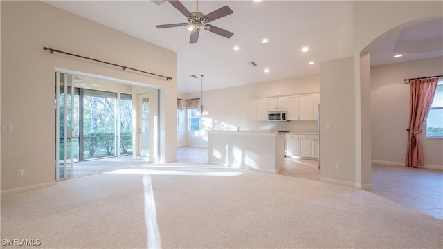11970 Bramble Cove Dr, Fort Myers, FL 33905 - unfurnished living room featuring arched walkways, plenty of natural light, recessed lighting, light colored carpet, and ceiling fan
