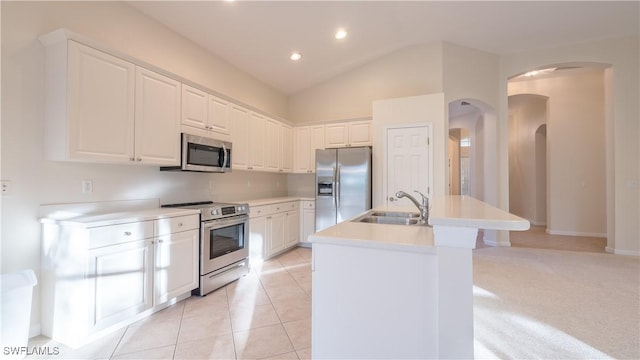 11970 Bramble Cove Dr, Fort Myers, FL 33905 - kitchen with appliances with stainless steel finishes, arched walkways, a center island with sink, white cabinetry, and light countertops