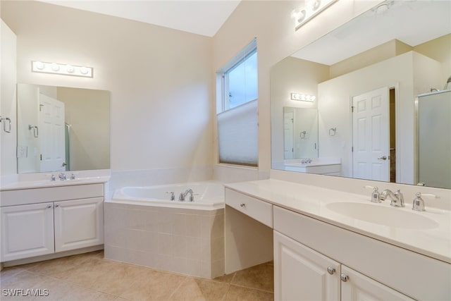 11970 Bramble Cove Dr, Fort Myers, FL 33905 - full bathroom with two vanities, a garden tub, a shower stall, and tile patterned floors