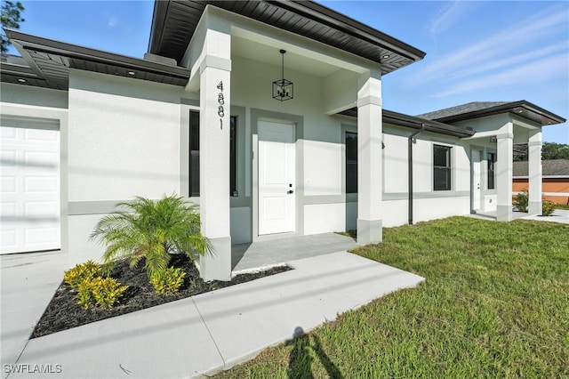4881/4883 Leonard Blvd S, Lehigh Acres, FL 33973 - entrance to property with stucco siding, a yard, and a garage